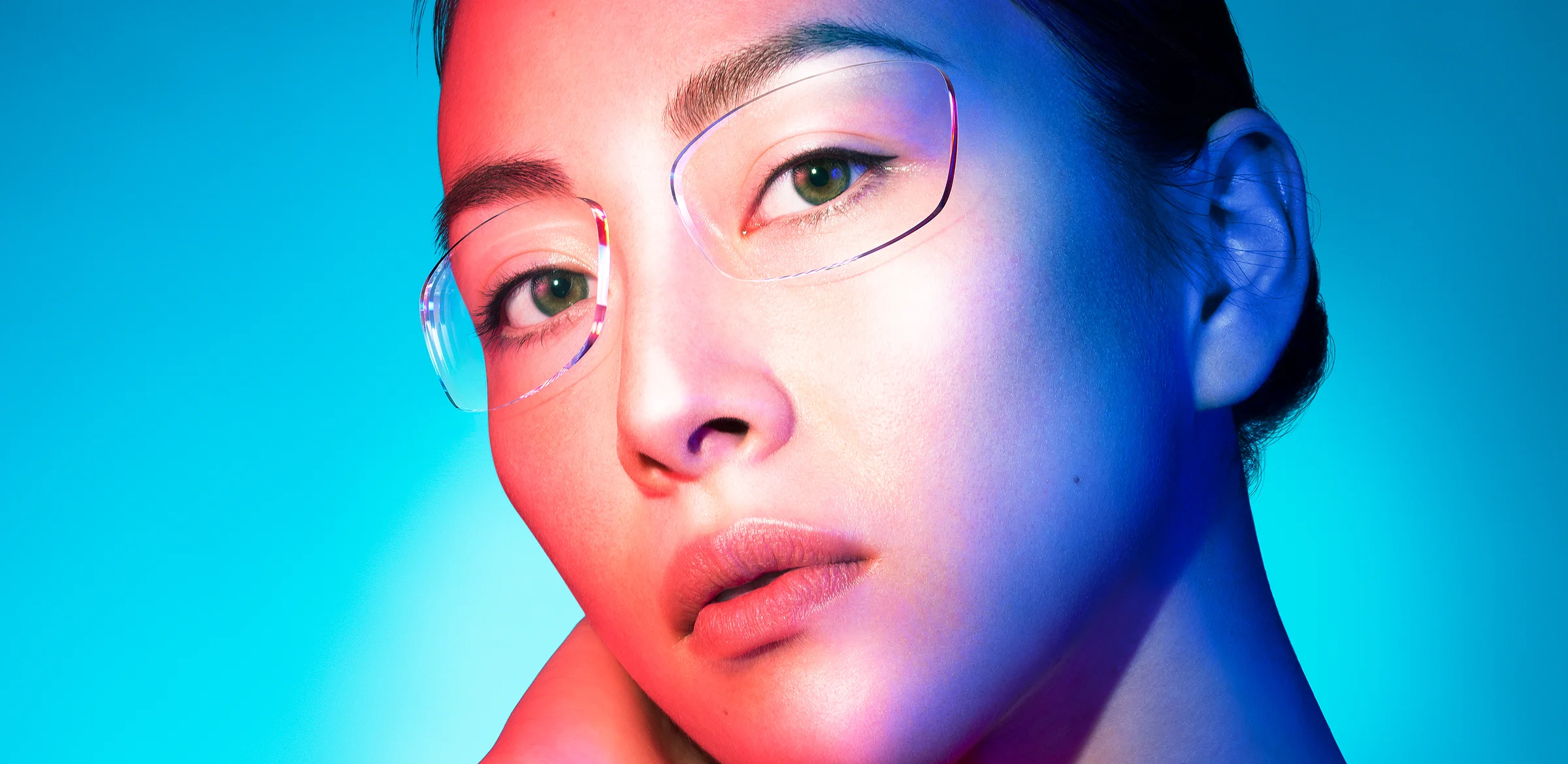 Woman with two ophthalmic lenses floating in front of her eyes for Nikon Lenswear’s ‘Seeing is’ campaign.